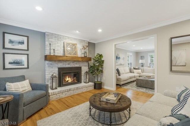 2 Columbia Dr, Bernardsville Boro, NJ 07924 - living room with recessed lighting, wood finished floors, ornamental molding, a brick fireplace, and baseboards
