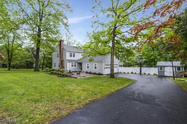2 Columbia Dr, Bernardsville Boro, NJ 07924 - view of side of home featuring driveway, a garage, a shed, a chimney, and an outbuilding