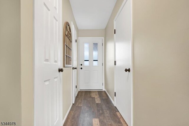 doorway to outside with baseboards and dark wood finished floors