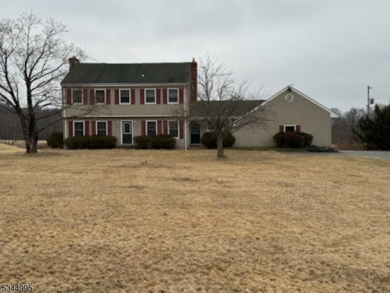 view of front of home featuring a front yard and a chimney