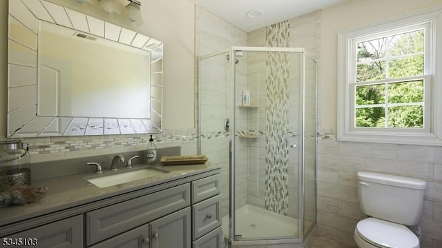 1121 N Washington Ave, Green Brook Twp, NJ 08812 - full bathroom with tile walls, a shower stall, vanity, toilet, and decorative backsplash