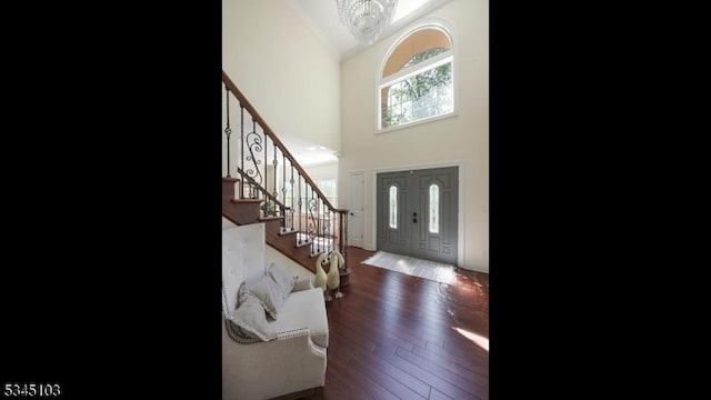 1121 N Washington Ave, Green Brook Twp, NJ 08812 - entrance foyer featuring a chandelier, high vaulted ceiling, stairway, and wood finished floors