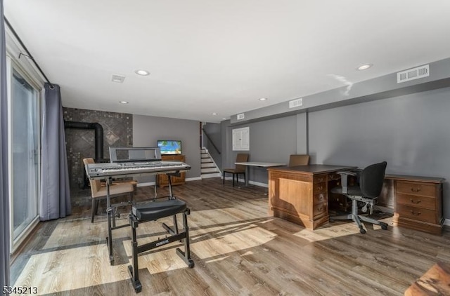 office featuring wood finished floors, baseboards, and recessed lighting