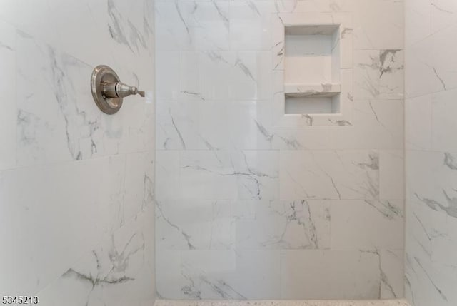 bathroom with tiled shower