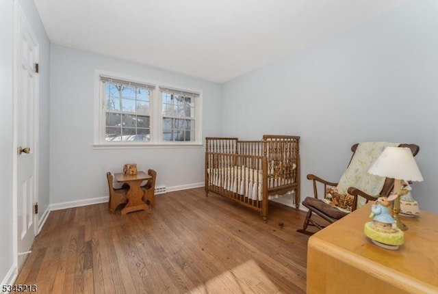 bedroom featuring hardwood / wood-style floors and baseboards