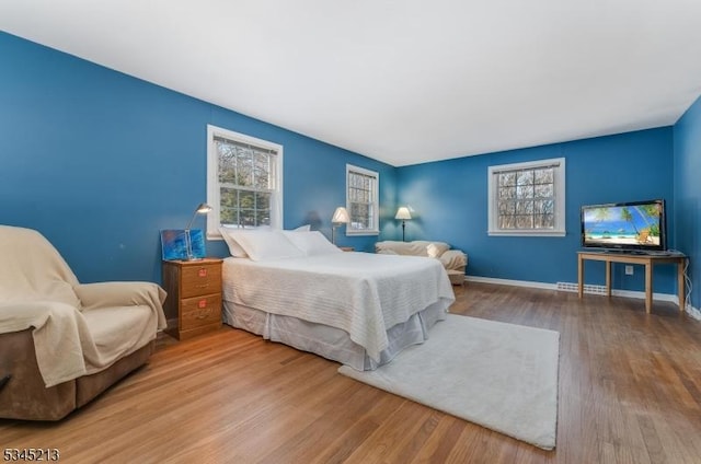 bedroom with wood finished floors and baseboards