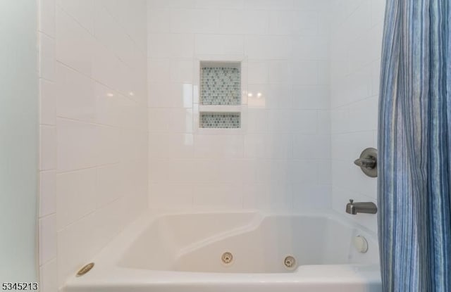 full bathroom with a combined bath / shower with jetted tub