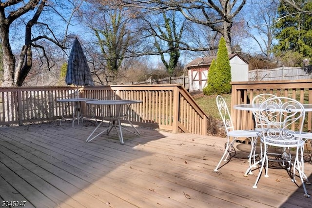 113 Circle Dr S, West Amwell Twp, NJ 08530 - wooden terrace featuring outdoor dining space, a shed, fence, and an outbuilding