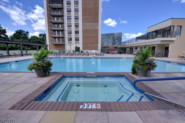 pool featuring a patio and a hot tub
