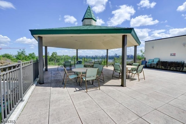 view of patio featuring outdoor dining space and fence