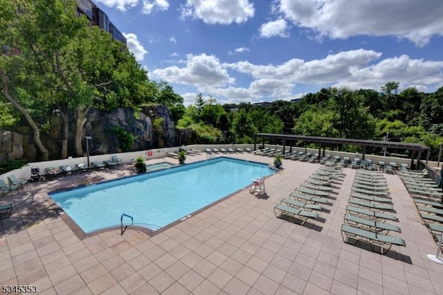 community pool featuring a patio area and fence