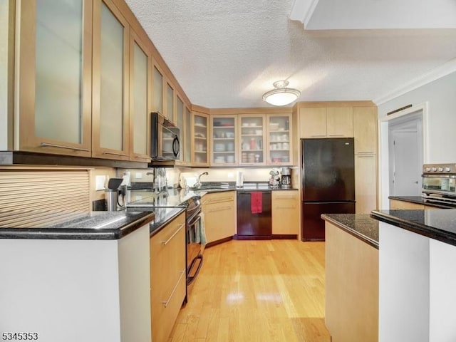 kitchen with light wood finished floors, black appliances, glass insert cabinets, a textured ceiling, and crown molding