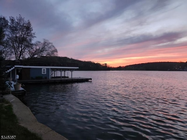 view of dock featuring boat lift and a water view