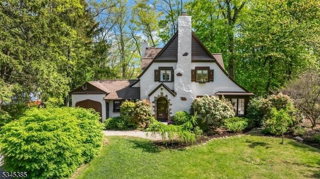 110 Kenilworth Rd, Mountain Lakes Boro, NJ 07046 - view of front facade featuring a chimney, a front yard, stucco siding, and a garage
