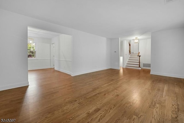 6 Ronarm Dr, Mountain Lakes Boro, NJ 07046 - unfurnished living room with stairway, wood finished floors, and baseboards