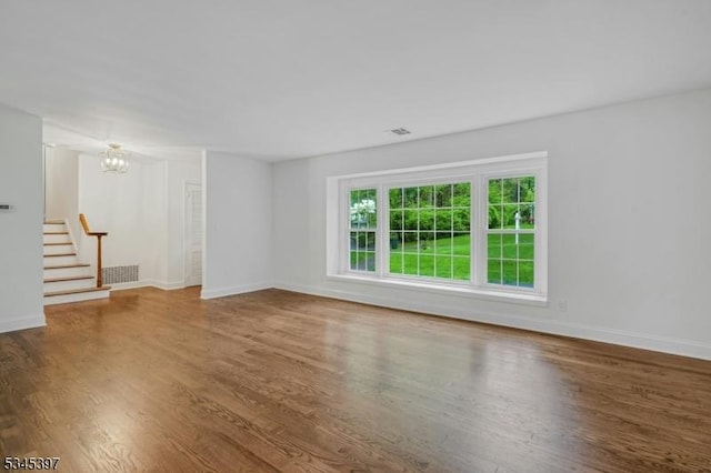 6 Ronarm Dr, Mountain Lakes Boro, NJ 07046 - unfurnished living room featuring stairs, wood finished floors, a chandelier, and baseboards