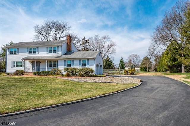 31 Riverview Ter, Hillsborough Twp, NJ 08844 - view of front of house with a front yard, driveway, covered porch, a chimney, and a garage