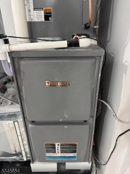 utility room featuring heating unit