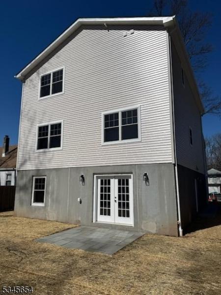 back of property with french doors and a patio area