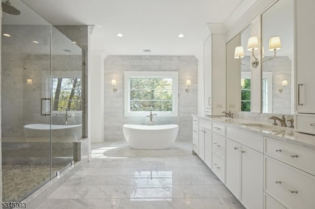 bathroom featuring plenty of natural light, a sink, marble finish floor, and double vanity