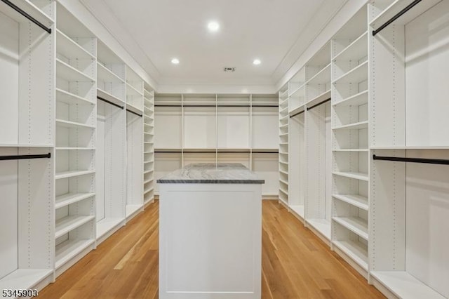 spacious closet featuring light wood-type flooring and visible vents