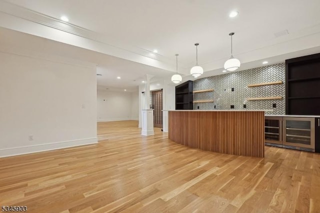 kitchen featuring pendant lighting, baseboards, open floor plan, recessed lighting, and light wood-type flooring