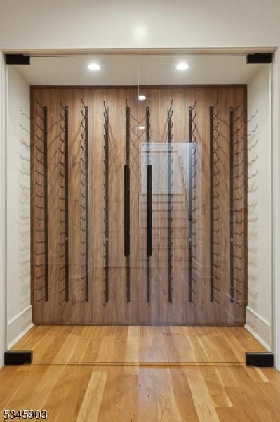 mudroom with recessed lighting, baseboards, and wood finished floors