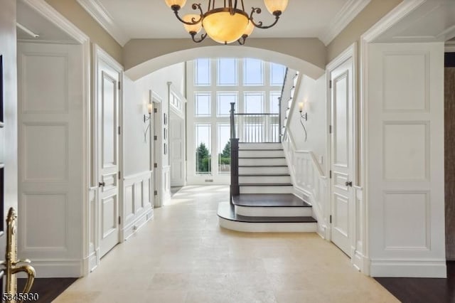 16 Laurel Mountain Way, Tewksbury Twp, NJ 07830 - foyer entrance featuring stairway, ornamental molding, arched walkways, a decorative wall, and a notable chandelier