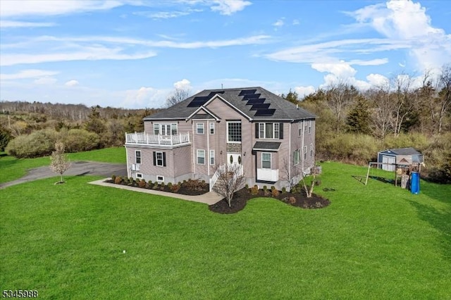 10 County Road 519, Hampton Twp, NJ 07860 - view of front of home featuring a balcony, solar panels, a front yard, and an outdoor structure