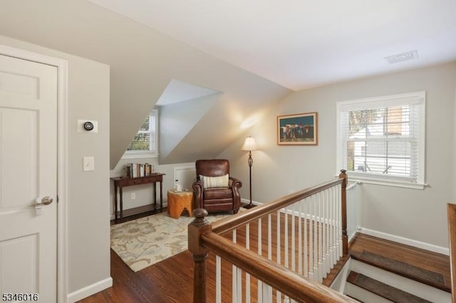 bedroom featuring wood finished floors, multiple windows, vaulted ceiling, and baseboards