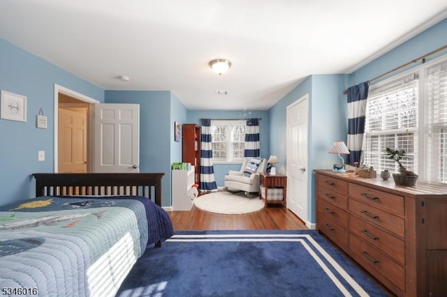 bedroom featuring wood finished floors and baseboards