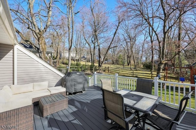 wooden deck with outdoor dining space, outdoor lounge area, and area for grilling