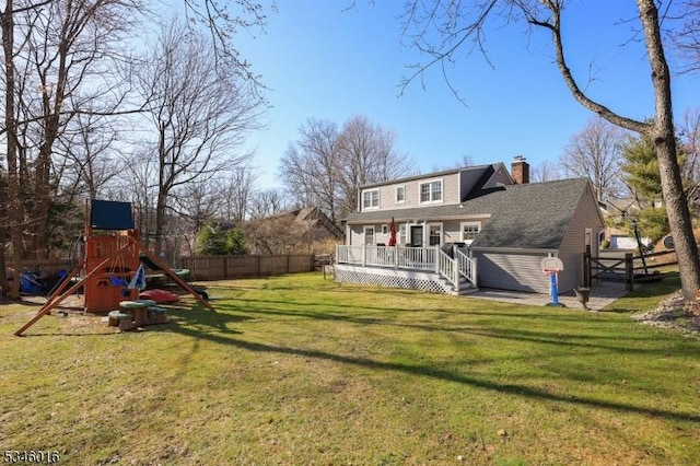 view of yard with a wooden deck and a playground
