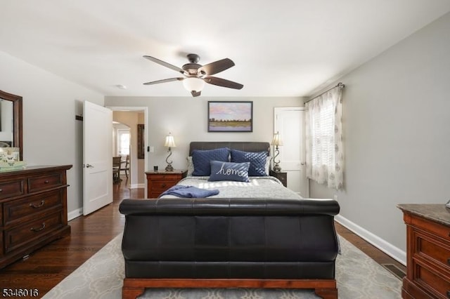 bedroom featuring baseboards, dark wood-style floors, and ceiling fan