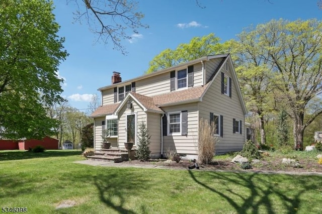 view of front of property with a chimney and a front yard