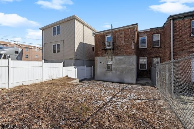 back of house featuring fence