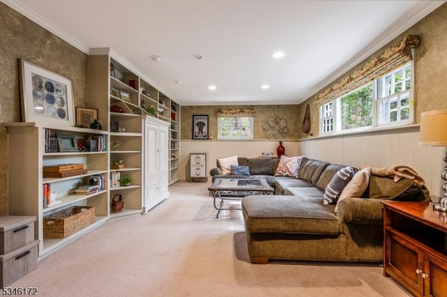 sitting room featuring crown molding, a wainscoted wall, light carpet, and a wealth of natural light