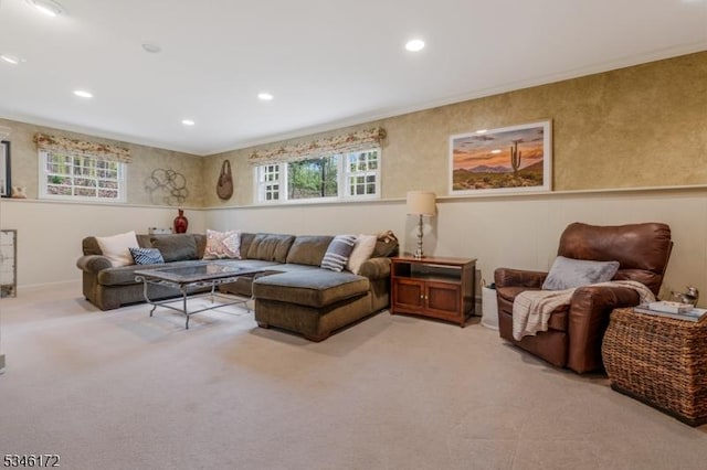 living room with light colored carpet, crown molding, and a wealth of natural light