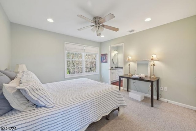 carpeted bedroom with recessed lighting, baseboards, and ensuite bathroom