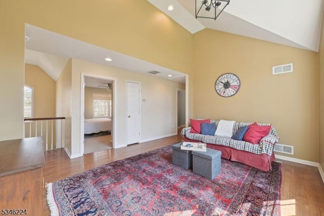living room featuring visible vents, wood finished floors, and a wealth of natural light