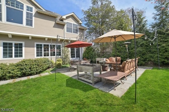 back of house with a lawn, a patio, and outdoor lounge area