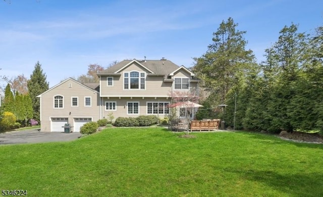 traditional home featuring a garage, driveway, and a front yard