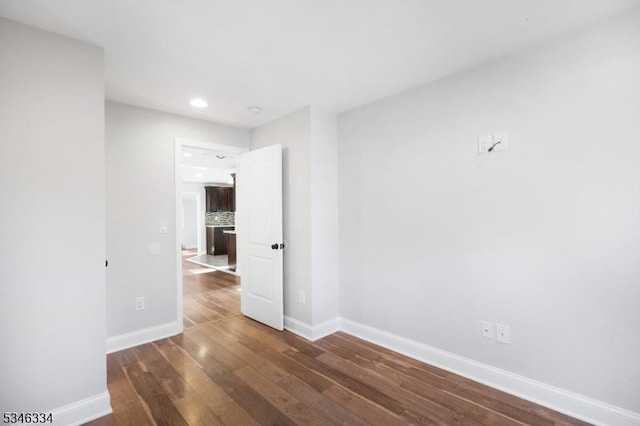 unfurnished room featuring recessed lighting, baseboards, and wood finished floors