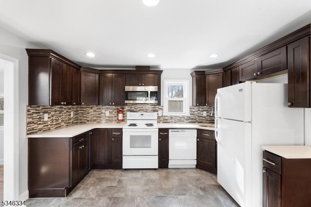 kitchen featuring backsplash, light countertops, dark brown cabinetry, and white appliances