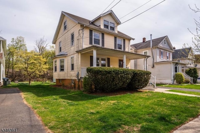 649 N Avenue Ext, Dunellen Boro, NJ 08812 - traditional style home with a front lawn and a porch