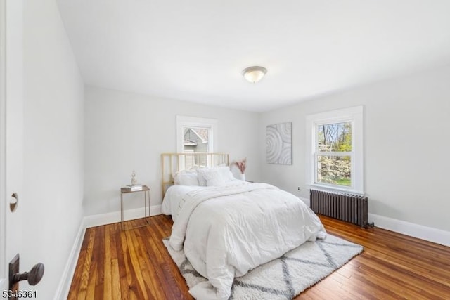 649 N Avenue Ext, Dunellen Boro, NJ 08812 - bedroom featuring radiator, multiple windows, baseboards, and wood finished floors