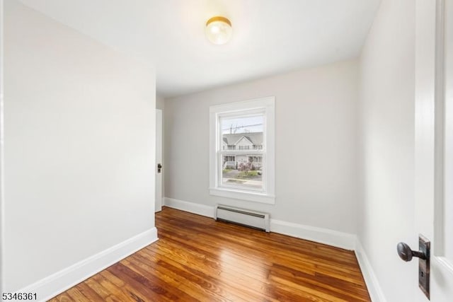 649 N Avenue Ext, Dunellen Boro, NJ 08812 - unfurnished room with baseboard heating, baseboards, and wood finished floors
