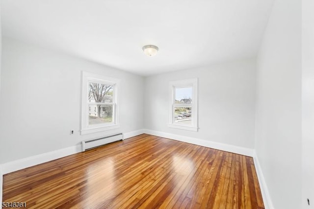 649 N Avenue Ext, Dunellen Boro, NJ 08812 - spare room featuring a baseboard radiator, healthy amount of natural light, hardwood / wood-style flooring, and baseboards