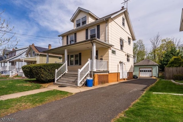649 N Avenue Ext, Dunellen Boro, NJ 08812 - american foursquare style home featuring covered porch, a detached garage, an outdoor structure, driveway, and a front yard