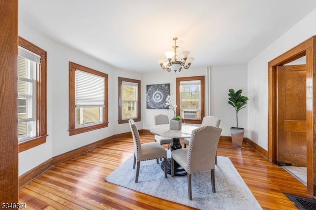 649 N Avenue Ext, Dunellen Boro, NJ 08812 - dining space with a chandelier, healthy amount of natural light, light wood-style floors, and baseboards
